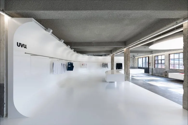 UVU Seongsu flagship upper floor retail space with curved wall and clothing rail